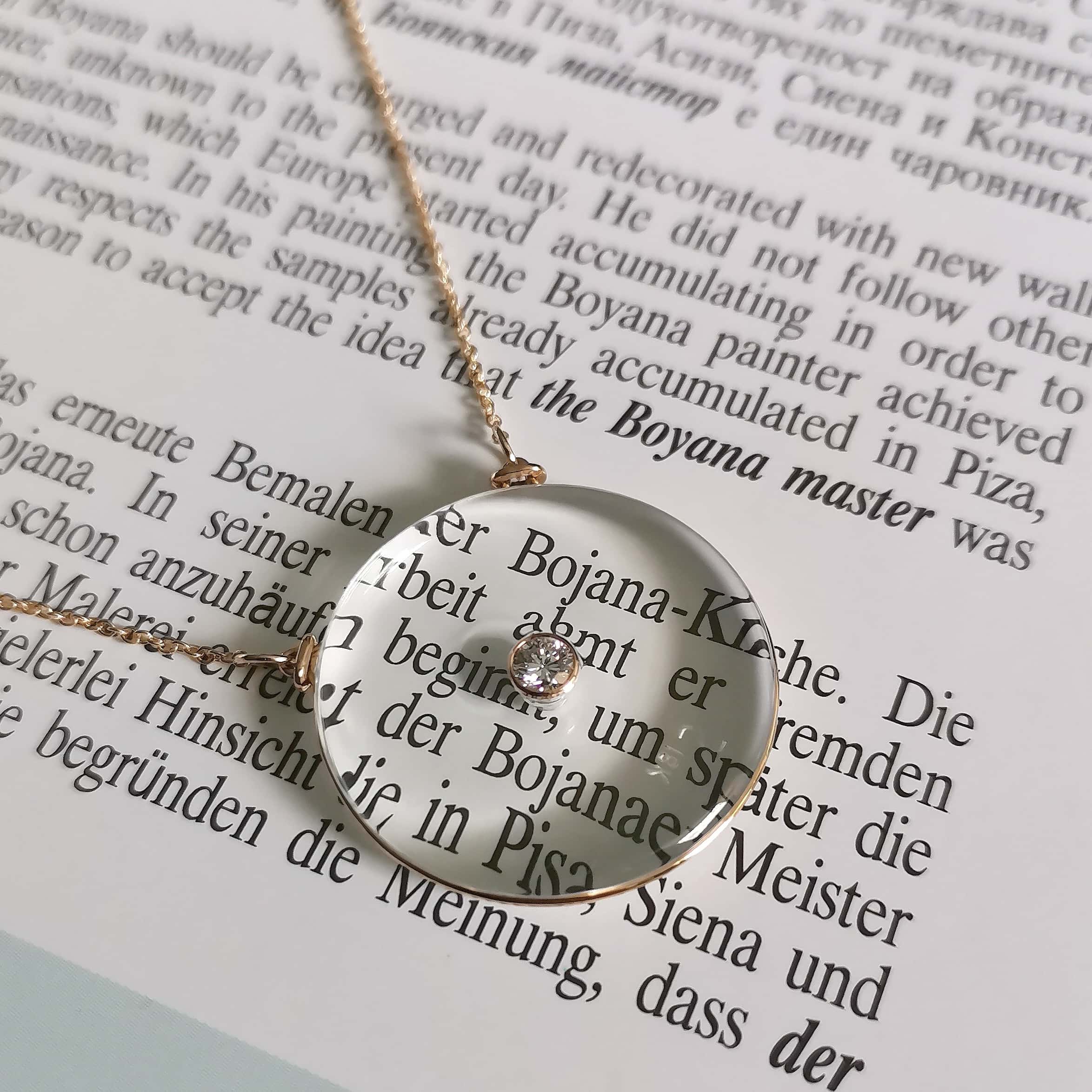 Gold filigree pendant catching morning light