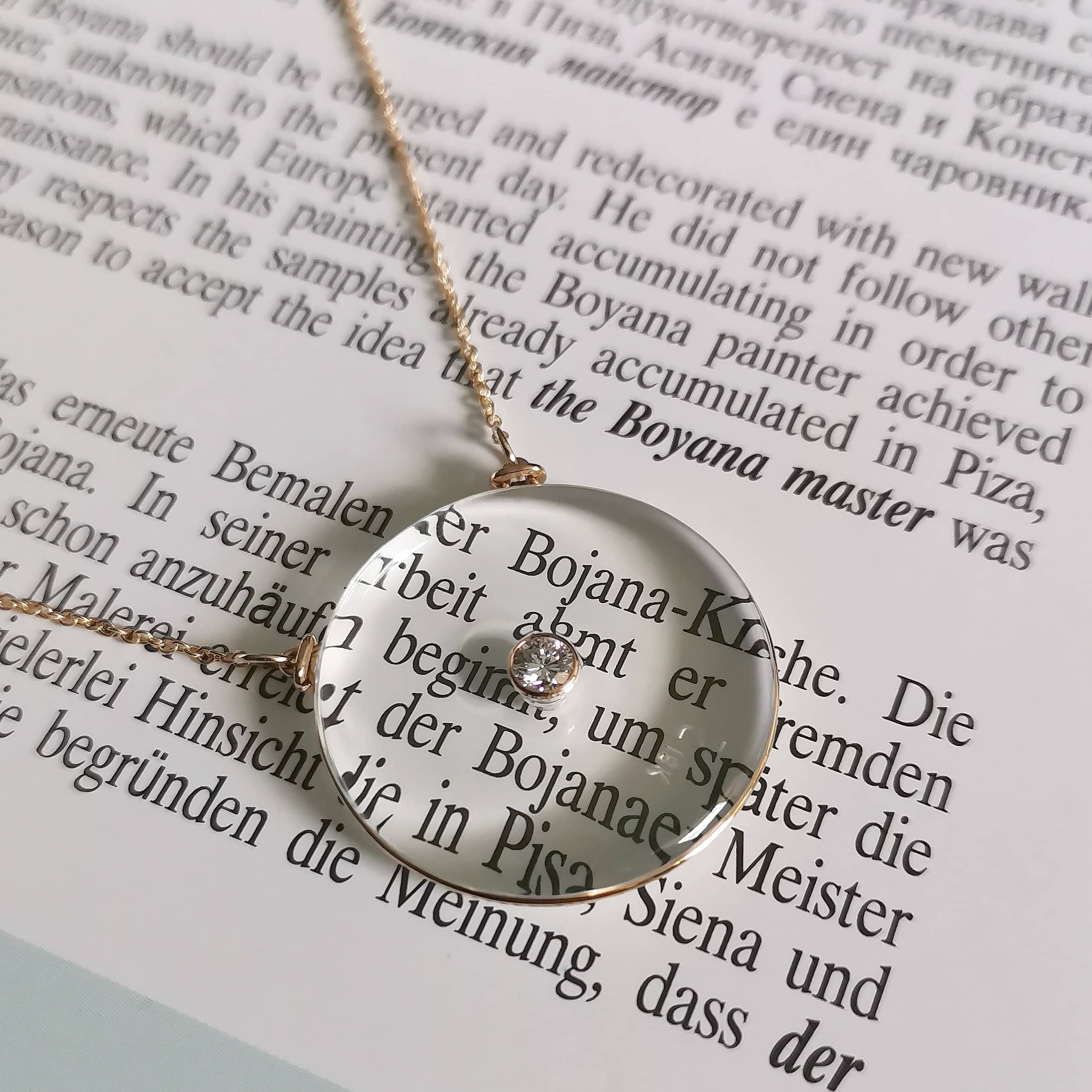 Gold filigree pendant catching morning light